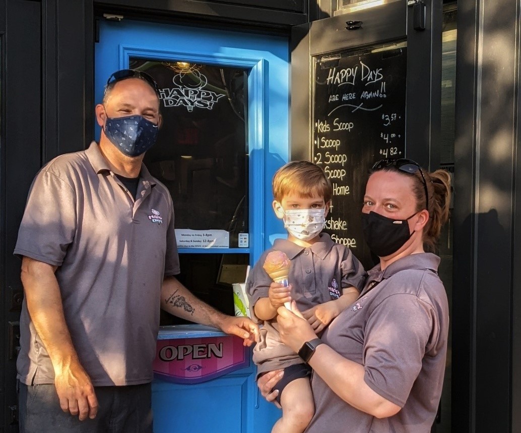 James Tammy and their son in front of Happy Days Ice Cream parlour